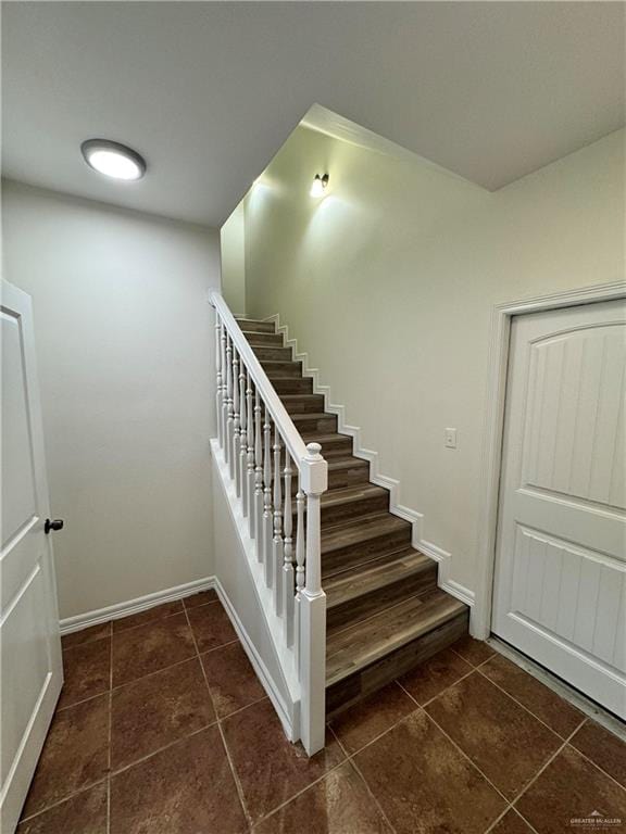 staircase featuring tile patterned floors