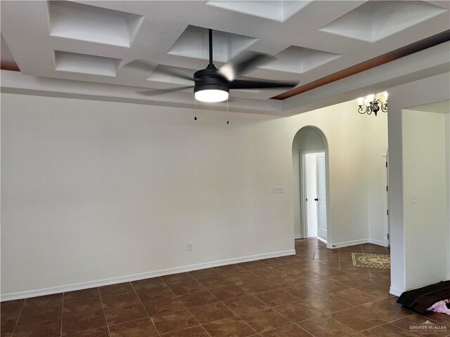 tiled empty room featuring beam ceiling, ceiling fan with notable chandelier, and coffered ceiling