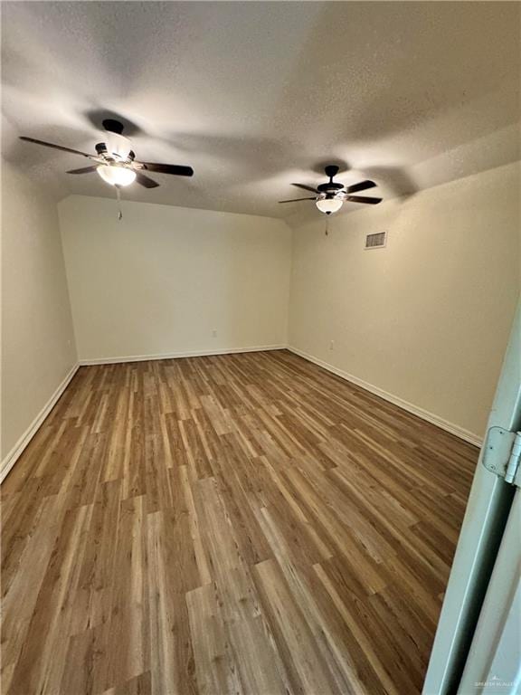 empty room featuring hardwood / wood-style floors and a textured ceiling