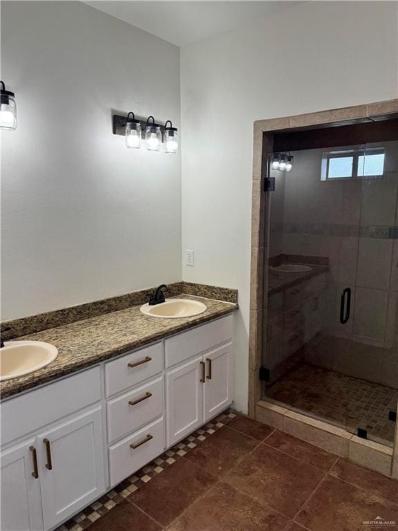 bathroom featuring tile patterned floors, vanity, and a shower with shower door