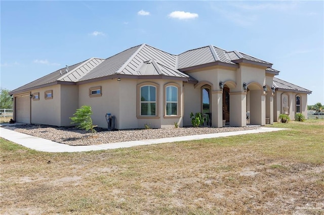 view of front of home with a garage and a front yard