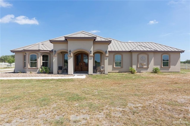 mediterranean / spanish-style home with a front lawn