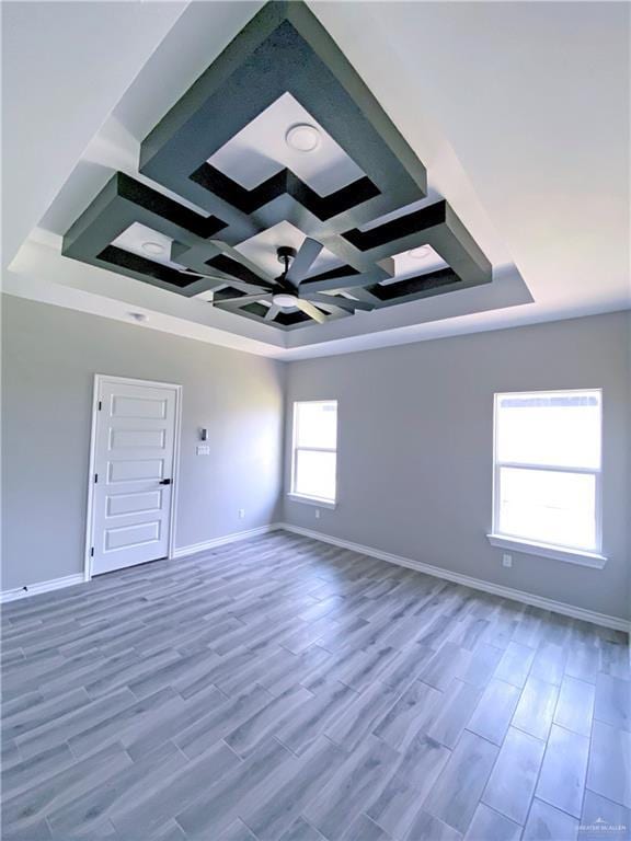 unfurnished room featuring hardwood / wood-style flooring and a raised ceiling