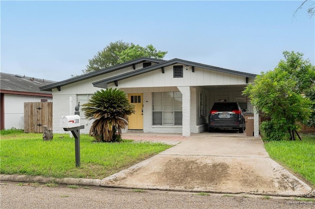 1008 Monterrey St, Edinburg, TX 78539 - view of front of home with driveway, brick siding, and an attached carport