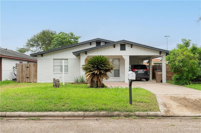 1008 Monterrey St, Edinburg, TX 78539 - view of front of house with driveway, an attached carport, and brick siding
