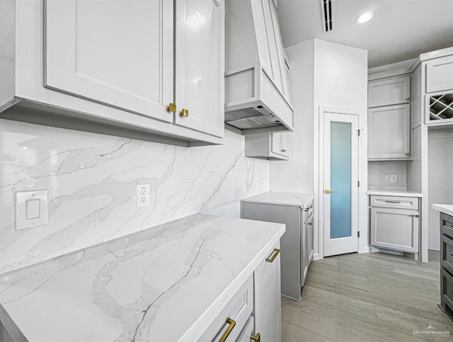 kitchen with recessed lighting, visible vents, gray cabinets, decorative backsplash, and light stone countertops