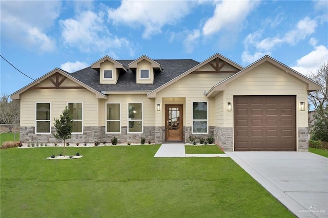 craftsman house with a garage, a shingled roof, concrete driveway, stone siding, and a front lawn