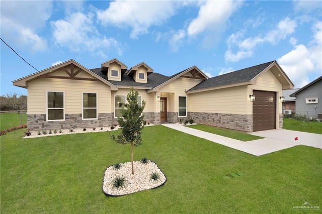 craftsman-style home with stone siding, a front lawn, and concrete driveway