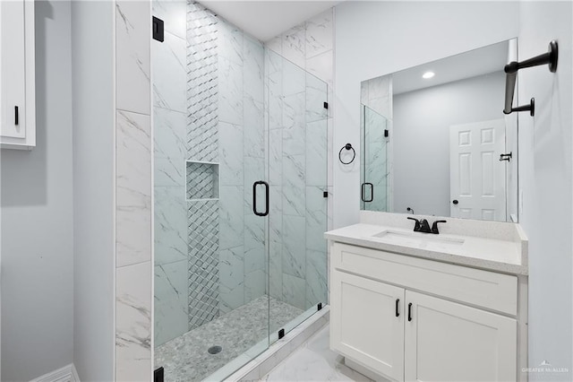 bathroom featuring an enclosed shower and vanity