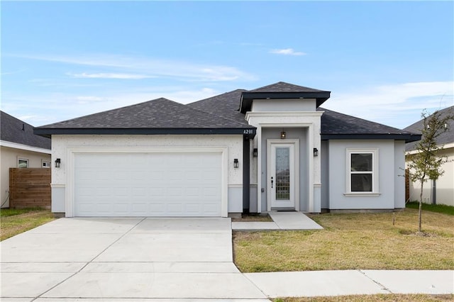 prairie-style home featuring a front lawn and a garage