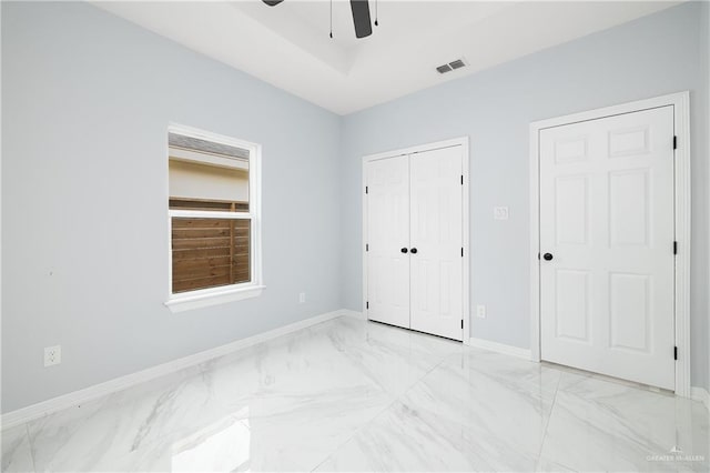 unfurnished bedroom featuring ceiling fan