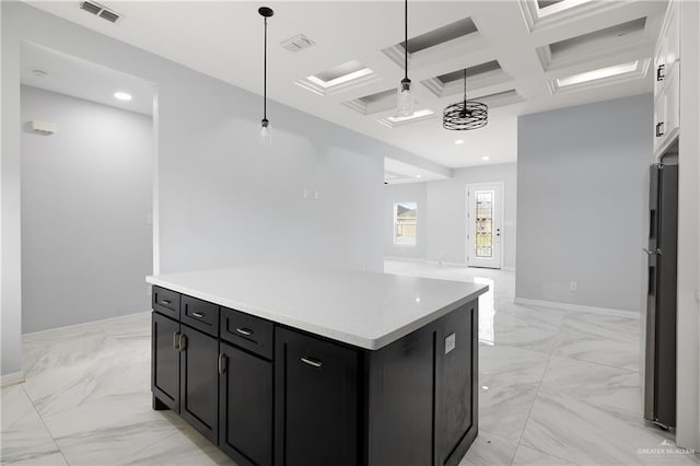 kitchen with a center island, pendant lighting, beamed ceiling, coffered ceiling, and black refrigerator