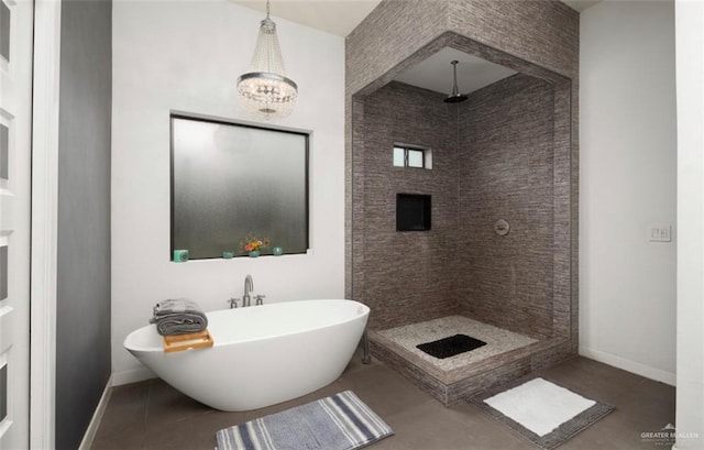 bathroom featuring tile patterned flooring, independent shower and bath, and a chandelier