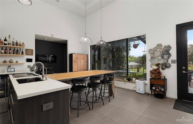 kitchen featuring plenty of natural light, sink, hanging light fixtures, and a kitchen island with sink