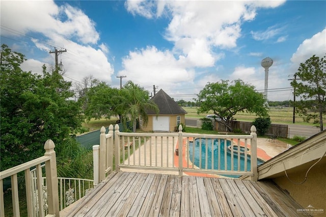 wooden deck with a fenced in pool, an outdoor structure, and fence