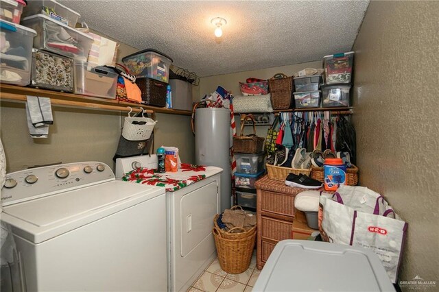 clothes washing area featuring laundry area, a textured wall, independent washer and dryer, and water heater