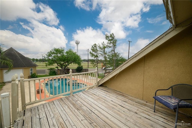 deck featuring a fenced in pool