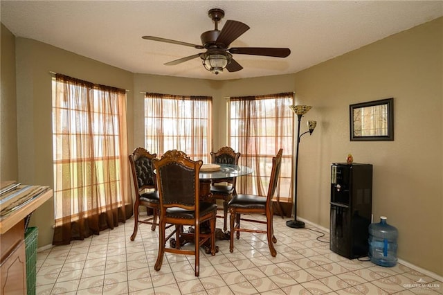 dining room with baseboards, a textured ceiling, and ceiling fan