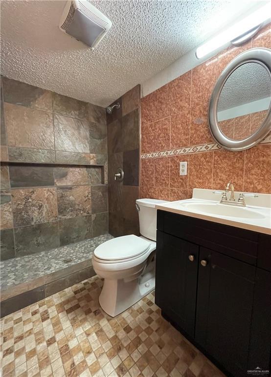 interior space with baseboards, a textured ceiling, ceiling fan, and carpet flooring