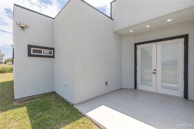 701 Santa Cecilia St, Donna, TX 78537 - entrance to property with stucco siding, a patio area, and a lawn