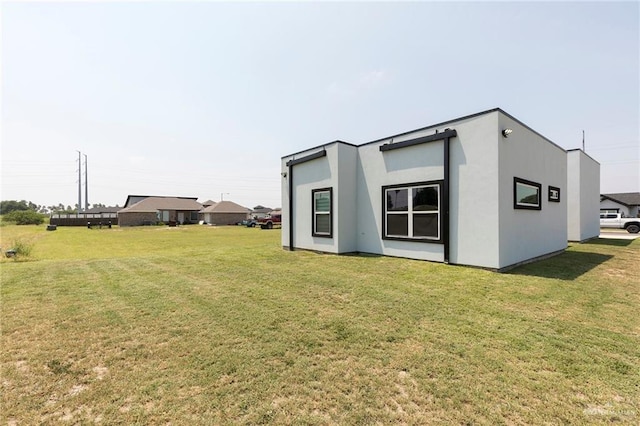 701 Santa Cecilia St, Donna, TX 78537 - view of property exterior featuring a lawn and stucco siding