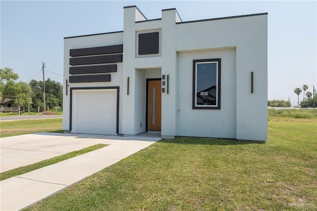 701 Santa Cecilia St, Donna, TX 78537 - modern home featuring a front yard, concrete driveway, stucco siding, and a garage