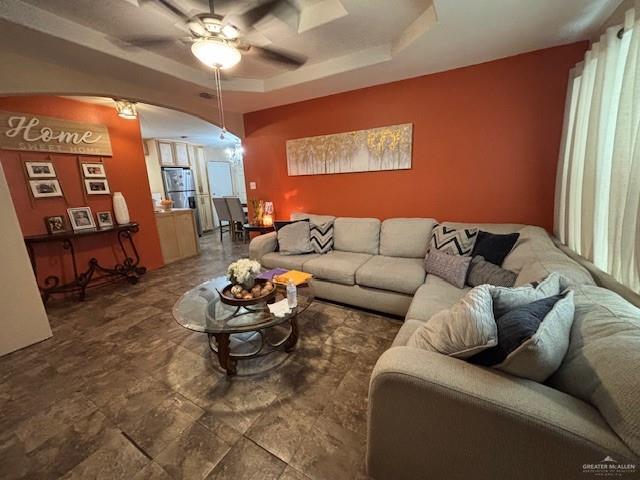 404 Flores St, Pharr, TX 78577 - living room with ceiling fan, arched walkways, and a raised ceiling