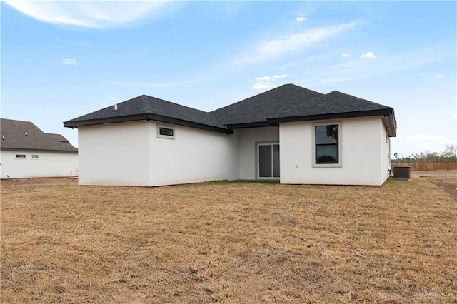 back of house featuring central AC and a lawn