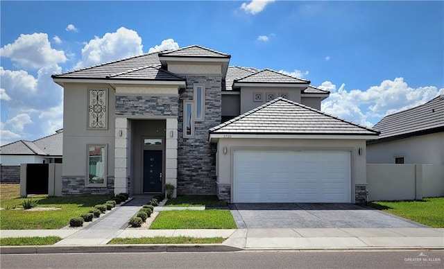 view of front of house with a garage and a front lawn