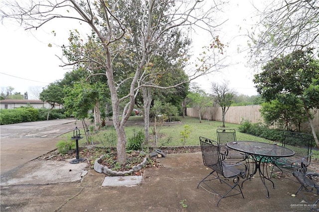 view of patio featuring outdoor dining area and fence