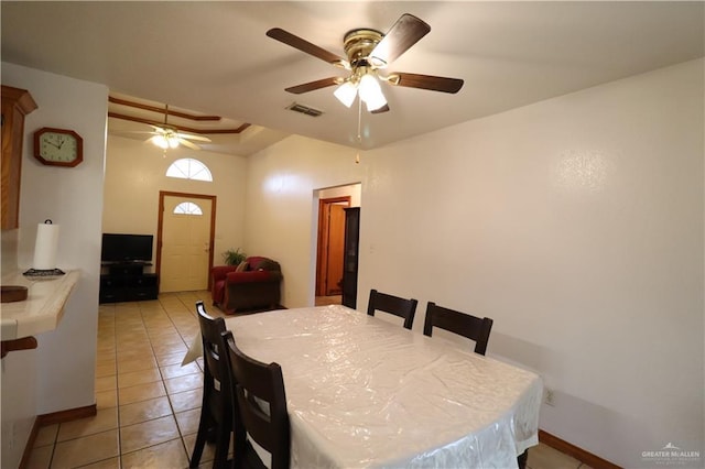 dining area with light tile patterned floors, ceiling fan, visible vents, and baseboards