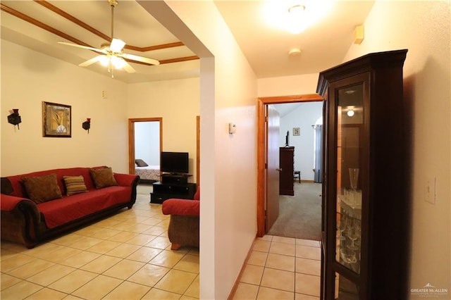 living room featuring light tile patterned floors and a ceiling fan