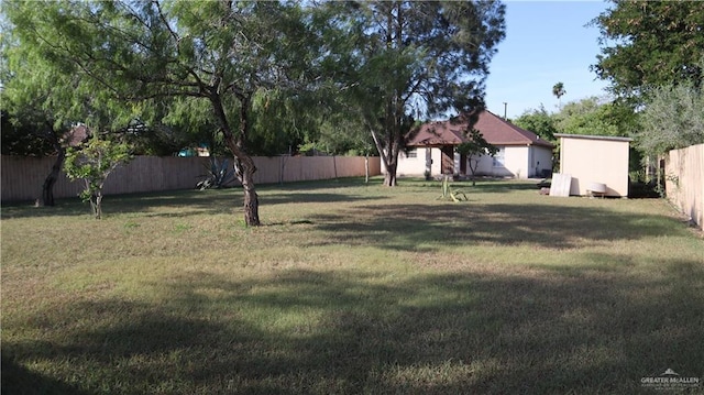 view of yard featuring a shed and a fenced backyard