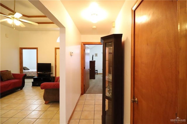 hallway featuring light tile patterned floors and baseboards