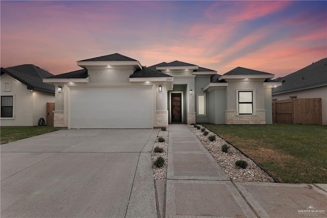 prairie-style home with a yard and a garage