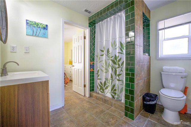 bathroom with vanity, walk in shower, and toilet