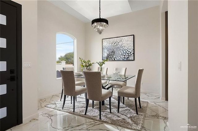 dining space with an inviting chandelier