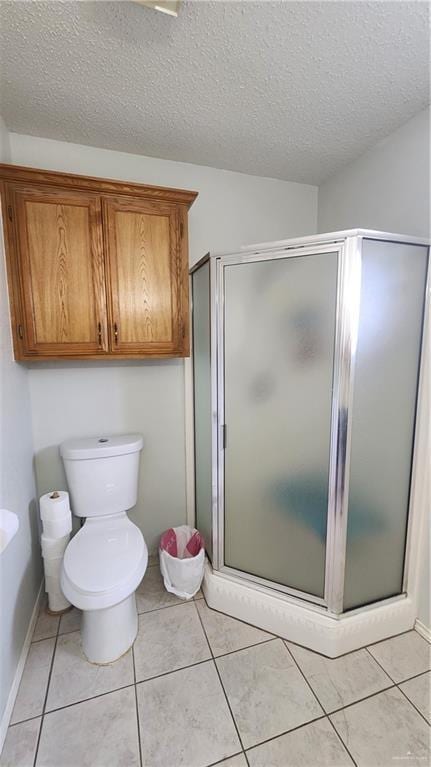 2434 Starling Cir E, Palmview, TX 78572 - full bathroom featuring tile patterned flooring, a textured ceiling, and a stall shower