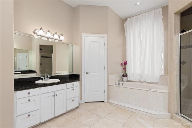 bathroom featuring vanity, tile patterned flooring, and plus walk in shower