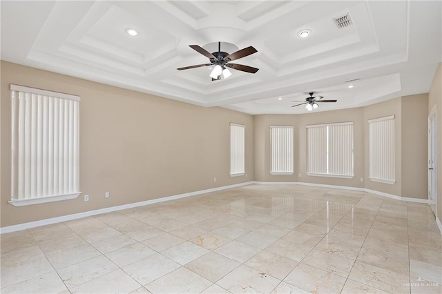 spare room with ceiling fan and coffered ceiling