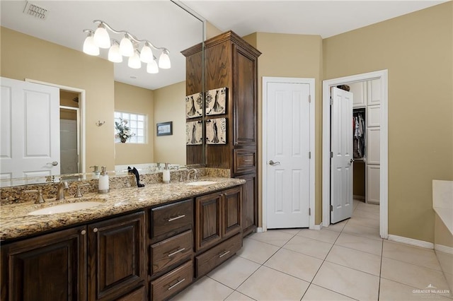 bathroom with tile patterned flooring and vanity