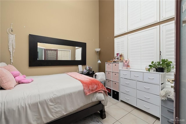 bedroom with light tile patterned floors