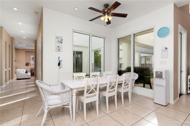 tiled dining space featuring ceiling fan