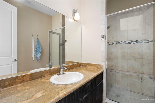 bathroom with vanity and an enclosed shower