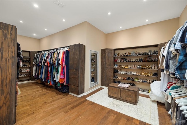 walk in closet with hardwood / wood-style floors