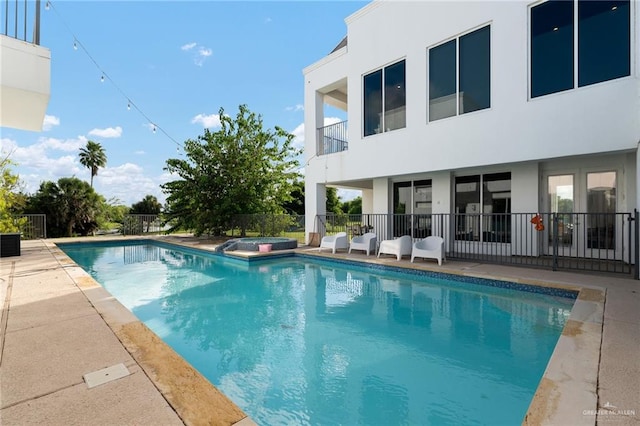 view of pool with an in ground hot tub and a patio