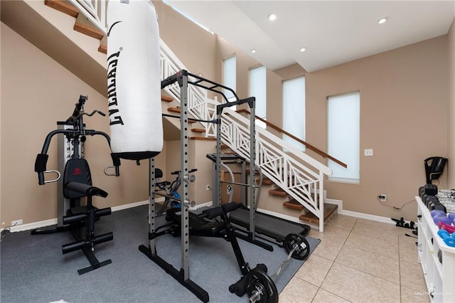 exercise room with light tile patterned floors