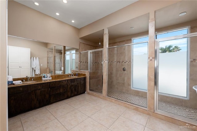 bathroom with tile patterned flooring, vanity, and walk in shower