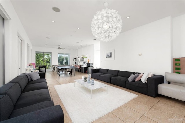 living room with ceiling fan with notable chandelier and light tile patterned flooring