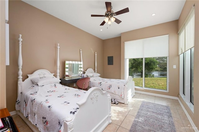 bedroom featuring electric panel, ceiling fan, and light tile patterned floors